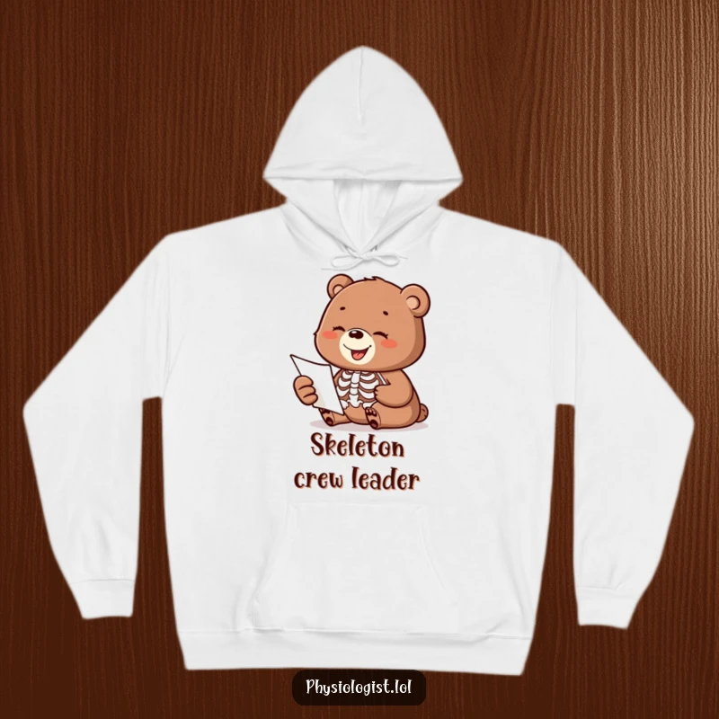 Funny hoodie with a happy bear cub observing a moving skeleton anatomy diagram, designed for cozy laughs.